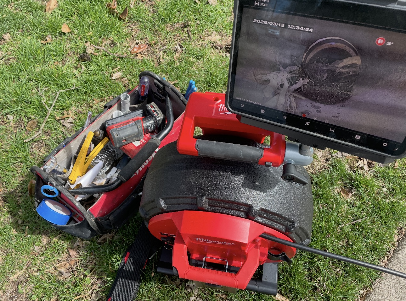 Sewer camera inspection monitor showing the inside of a damaged sewer line